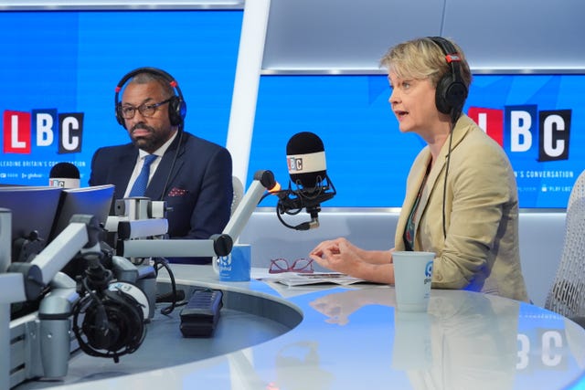 James Cleverly and Yvette Cooper, both wearing headphones and sitting in front of microphones, in the  LBC studio